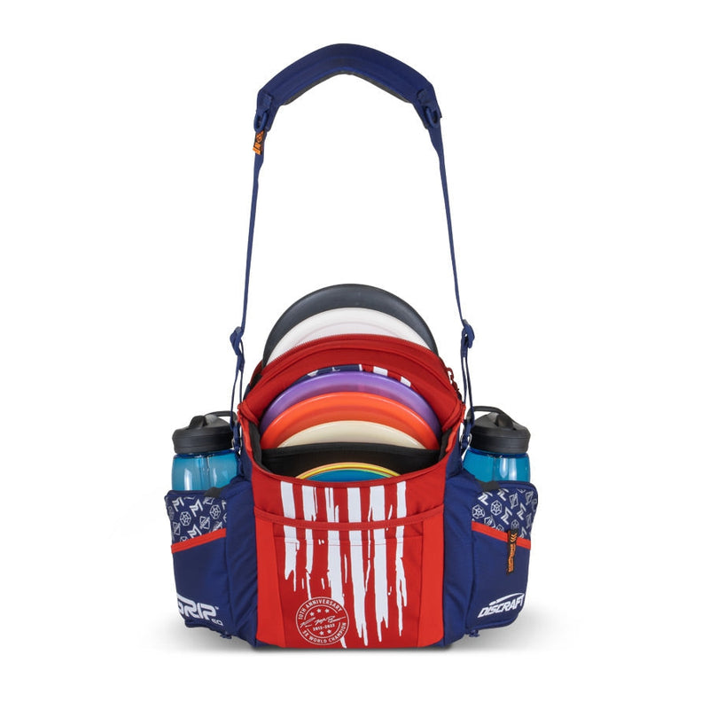 Red, white, and blue GRIP EQ G2 Series Paul McBeth disc golf bag with colorful discs and two water bottles.