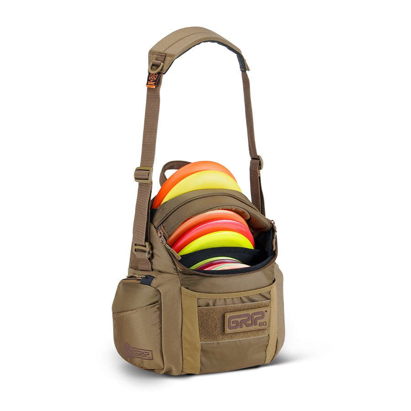Tan Grip EQ G2 Series disc golf bag with a padded shoulder strap, orange and yellow discs, and a large front pocket.