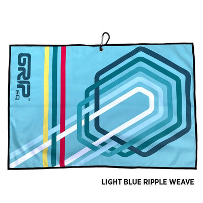Light blue Grip EQ GOAT disc golf towel with a black carabiner, bold vertical stripes, and a light blue hex design.