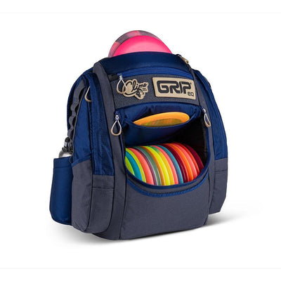 Navy and grey Grip EQ Ken Climo ATS disc golf bag with colorful discs and a pink disc on top.