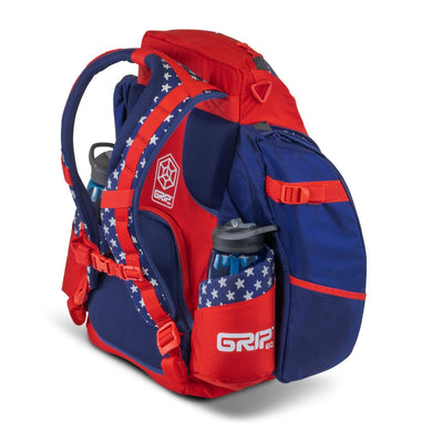 Red, white, and blue GRIPeq BX3 Series disc golf backpack with stars and two water bottles.
