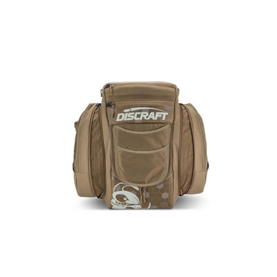 Brown GripEQ Discraft Buzzz BX3 disc golf bag with a Discraft logo, a skull graphic, and zippered pockets.