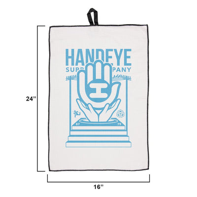 White Handeye waffle weave podium towel with a blue hand and "HANDEYE" logo and black trim.