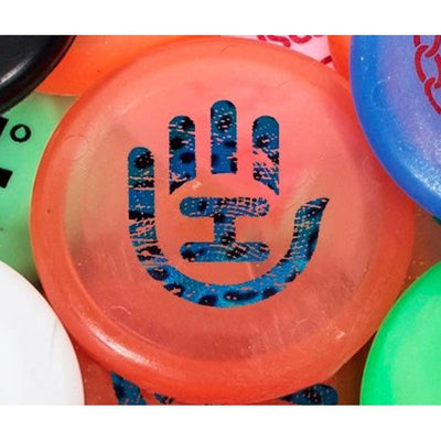 Translucent orange Handeye Zing Pico mini disc with a blue leopard print hand-shaped graphic in the center.