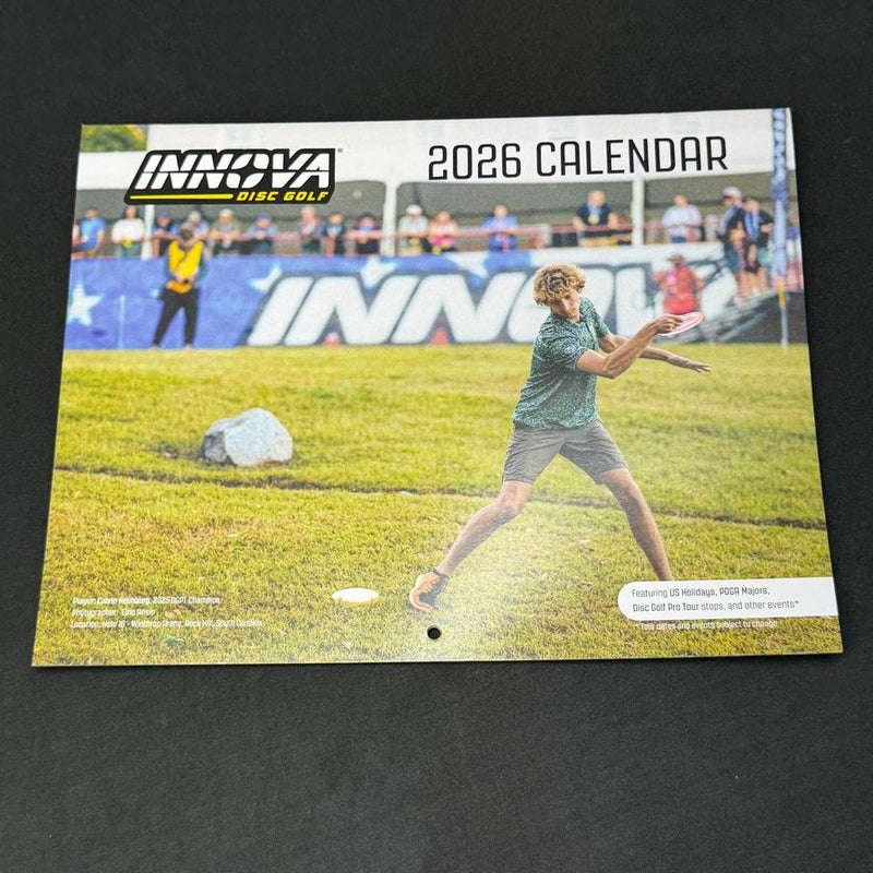 White Innova 2026 wall calendar cover featuring a disc golf player throwing a disc.