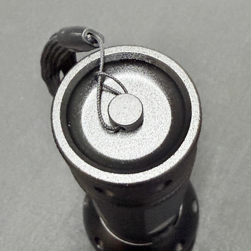 Close-up top view of an Innova 51 UV LED flashlight blacklight with a textured gray body and a black wrist strap.