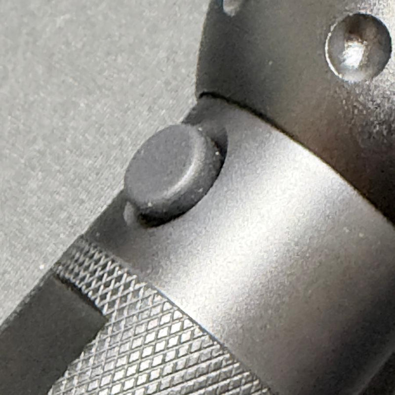Close up of the Innova 51 UV LED flashlight blacklight in a dark matte gray with a textured grip and button.