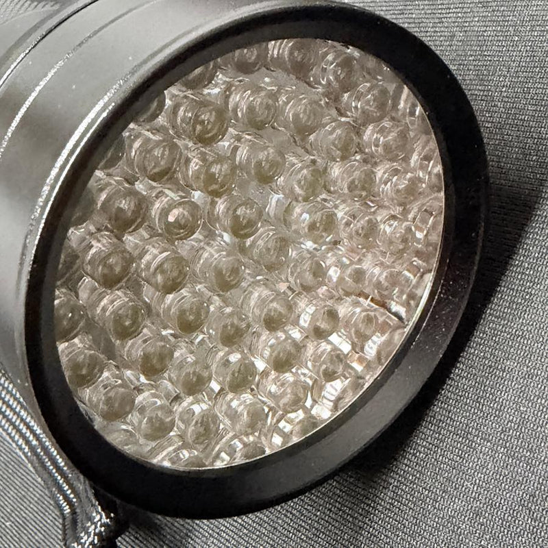 Close up of the silver Innova 51 UV LED flashlight blacklight with many small clear bulbs in a black ring.