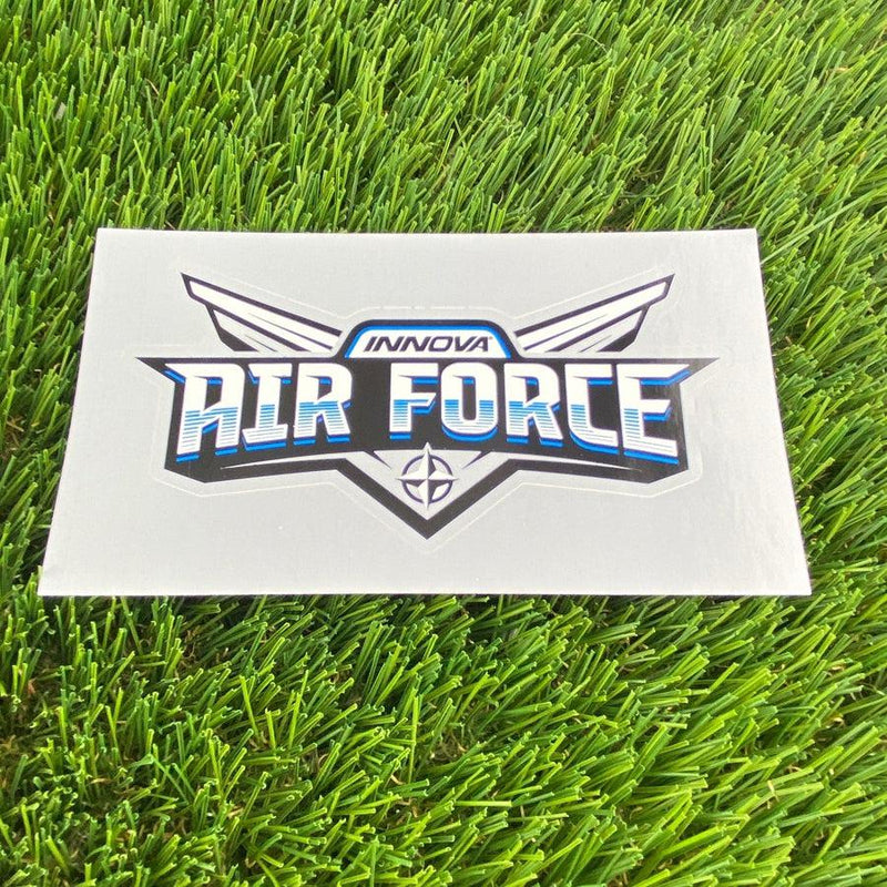 White vinyl Innova Air Force die cut sticker with blue lettering outlined in black, featuring subtle wing designs.