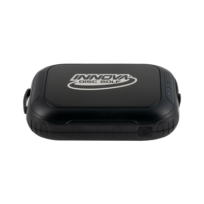 Black Innova Disc Golf hand warmer and battery pack with the brand logo and indicator lights visible.