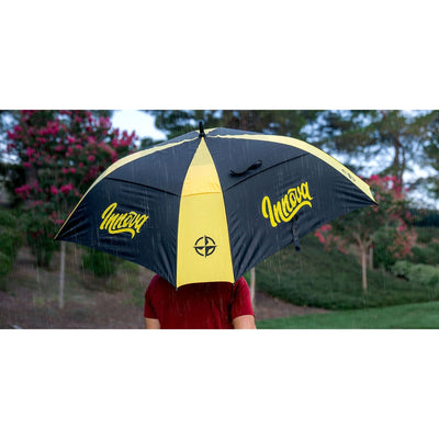 Black and yellow umbrella showcasing the Innova logo and a compass design during light rain.