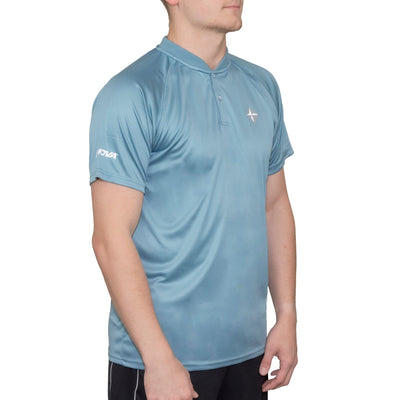 A man models a light blue Innova Blade polo shirt with a white Innova logo on the left sleeve.