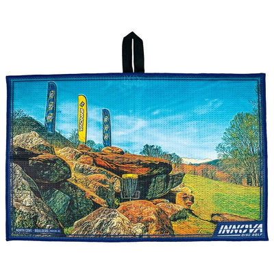 Blue Innova Tour Towel North Cove disc golf towel with a rocky course image, a yellow basket, and blue and yellow flags.