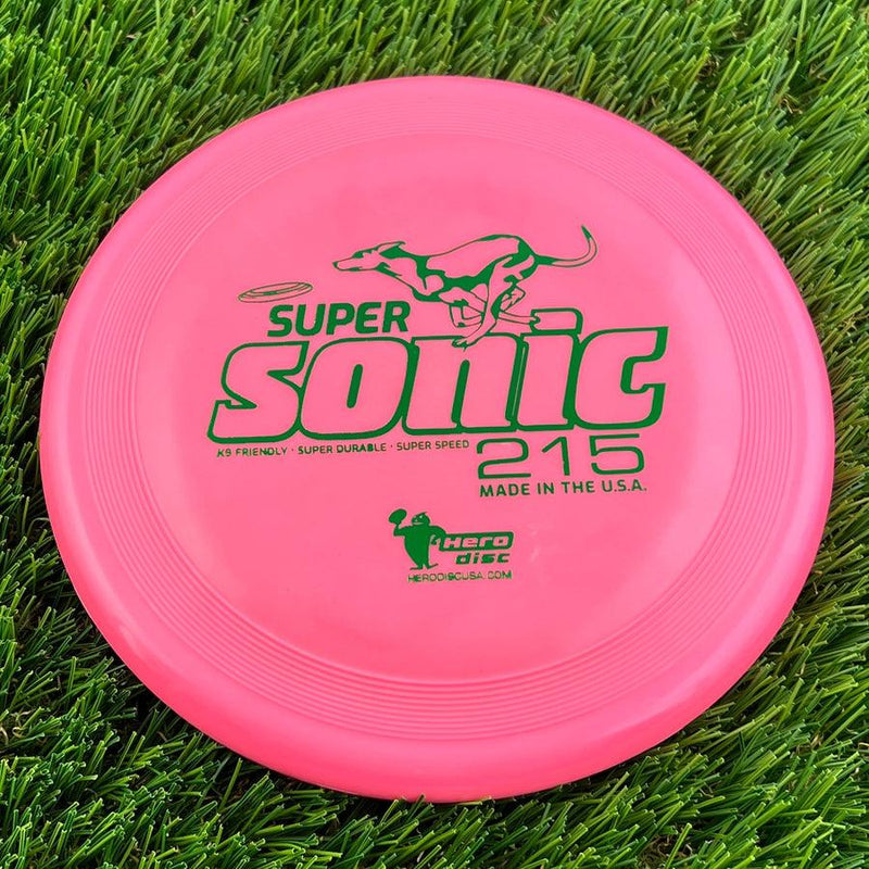 Bright pink Innova Super Sonic 215 Hero Disc with bold green lettering and a bounding dog graphic.