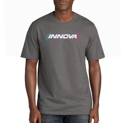 A person wearing a charcoal gray Innova Cypher New Era tri-blend t-shirt with a blue and pink glitch-style logo.