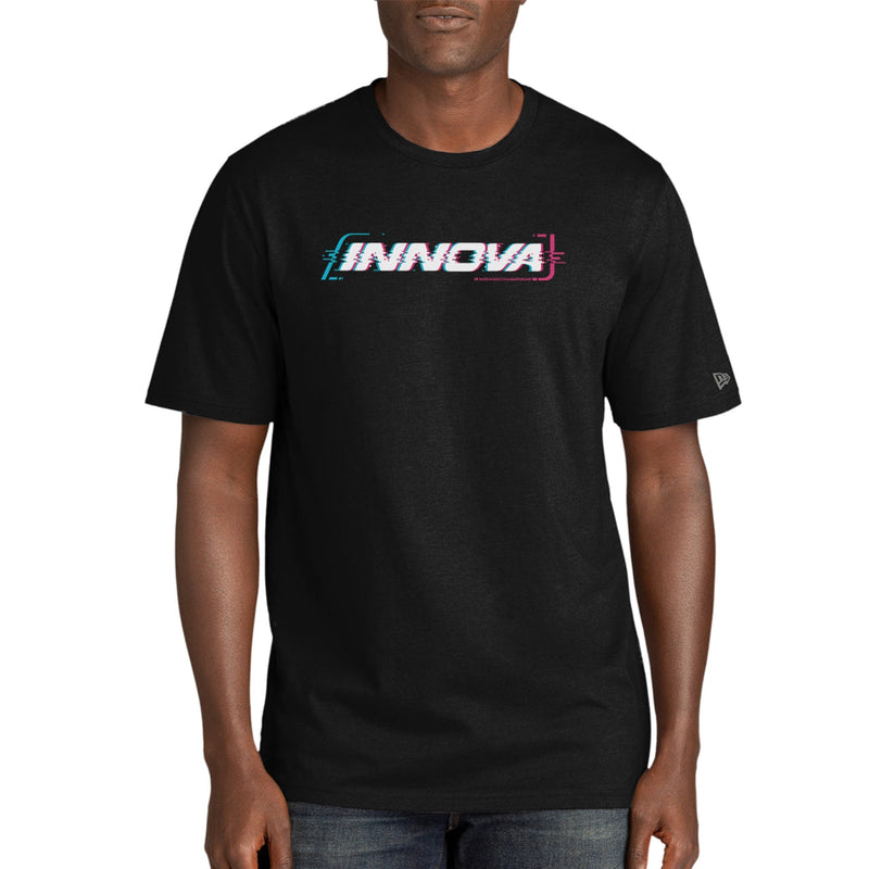 Man wearing a black Innova Cypher New Era Tri Blend T-shirt with a pixelated blue and pink logo.