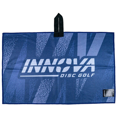 Blue waffle-weave Innova Disc Golf tour towel featuring a white Innova logo and textured blue patterning.