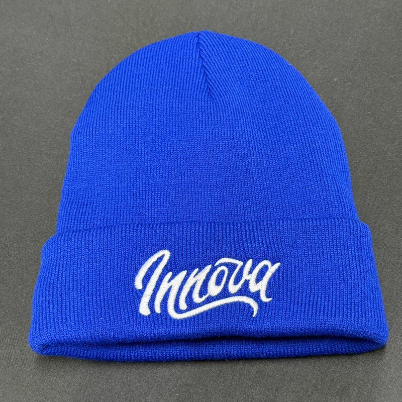 Vibrant blue knit Innova Flow Cuff Beanie with a white embroidered Innova script logo on its folded brim.