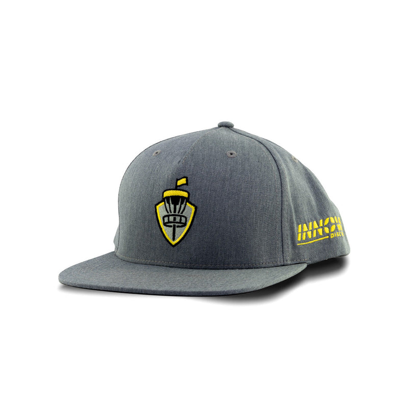 Gray Innova basket shield flatbill snapback hat with an embroidered yellow logo and side text.