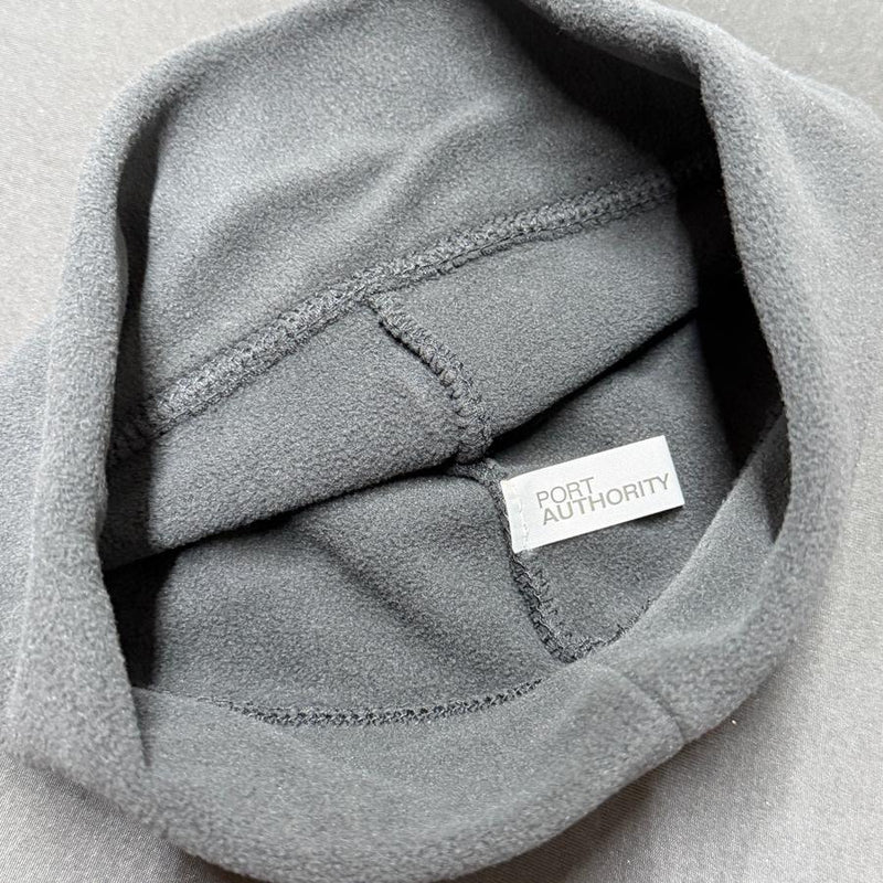 Gray fleece beanie with an inside white "PORT AUTHORITY" brand tag and visible stitching.