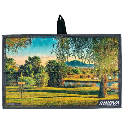 Gray Innova Wildhorse Tour Towel with a vibrant course landscape featuring trees and a disc golf basket.