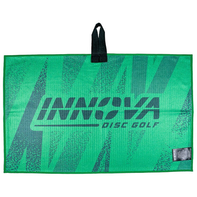 Vibrant green Innova disc golf tour towel with a textured gray logo and a black fabric loop for hanging.