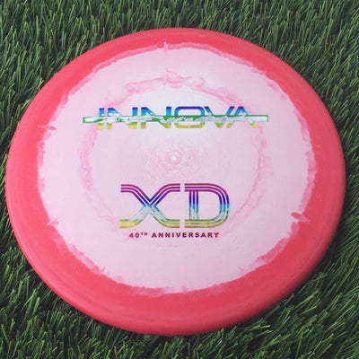 Solid red Innova Halo Nexus XD disc golf disc with a classic 40th Anniversary bar stamp in rainbow foil.