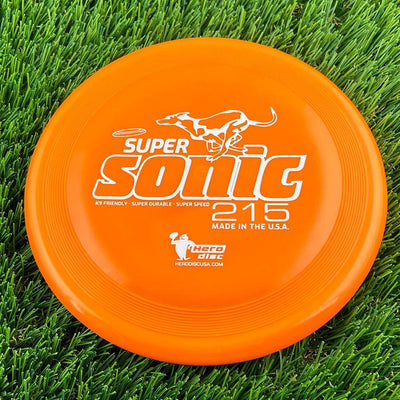 Bright orange Innova Hero Super Sonic 215 flying disc with white "SUPER SONIC" lettering and a running dog graphic.