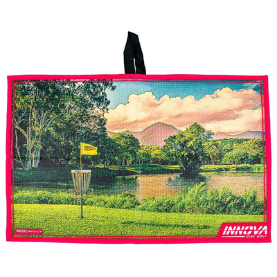 Innova Mauka Tour Towel with a vibrant disc golf course design, a pink border, and a black hanging loop.