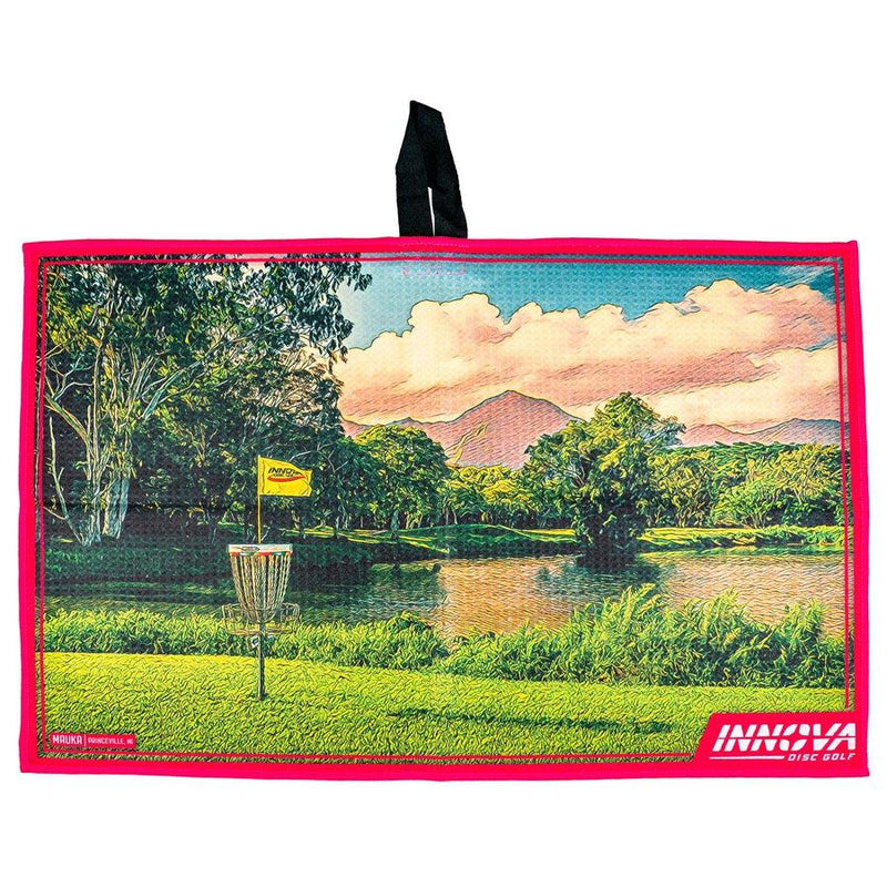 Innova Mauka Tour Towel with a vibrant disc golf course design, a pink border, and a black hanging loop.