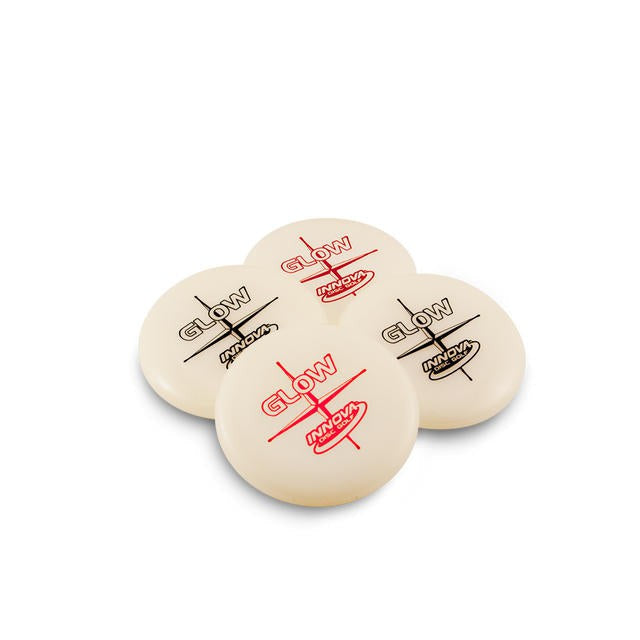Four off-white Innova Glow mini marker discs with red and black printing from an overhead view.