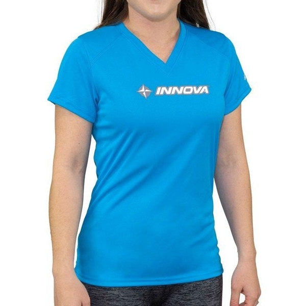 Bright teal Innova ladies performance tee with a white logo on the chest and a flattering V-neckline.