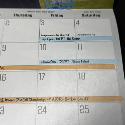 White Innova 2026 disc golf calendar page showing event dates like Heinola Open in blue and Women's Championships in orange.