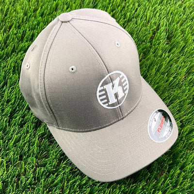 Grey Kastaplast Flexfit hat with a white "K" logo and a Flexfit sticker on the brim.