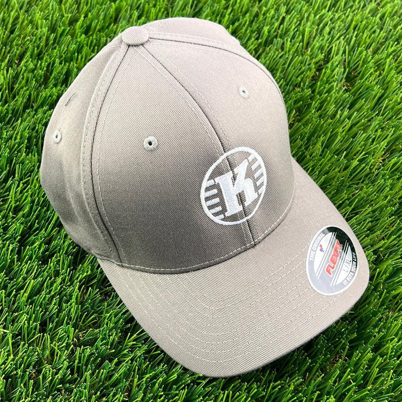 Grey Kastaplast Flexfit hat with a white "K" logo and a Flexfit sticker on the brim.