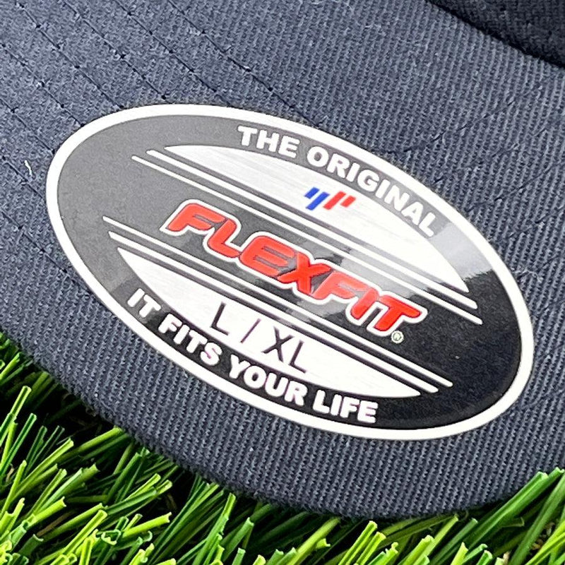 Navy blue Flexfit hat with a black and silver sticker label showing the brand name and size L, XL.