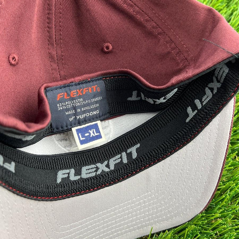 Inside view of a red Flexfit Kastaplast hat showing the sizing tag and embroidered Flexfit branding.