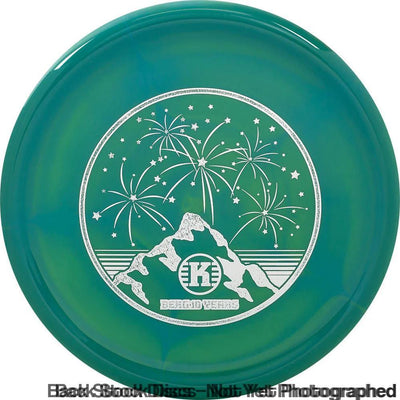 Teal and green swirled Kastaplast K1 Swirl Berg disc with a white 10 Year Anniversary mountain and fireworks stamp.