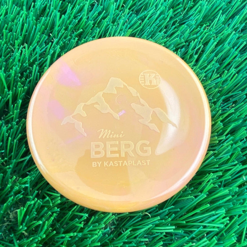 Yellow Kastaplast Mini Berg disc golf marker with an embossed mountain graphic and brand logo.