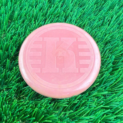 Pink Kastaplast K Mini Marker disc with a prominent embossed K-logo on its flat top surface.