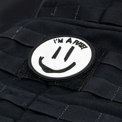 Round Latitude 64 collector patch with a white background, black smiley face, and the text "I'M A FUSE".