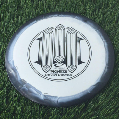 A white Latitude 64 Gold Line Orbit Pioneer disc golf disc with a black Kevin Kiefer Team Series 2023 stamp.