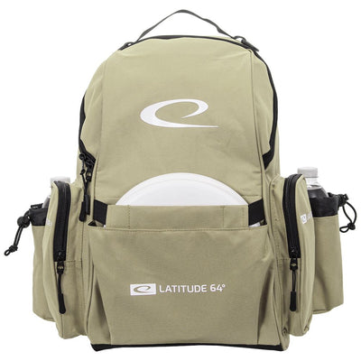 Khaki Latitude 64 Swift disc golf backpack with a white disc in the front pocket and two water bottles in mesh side pockets.