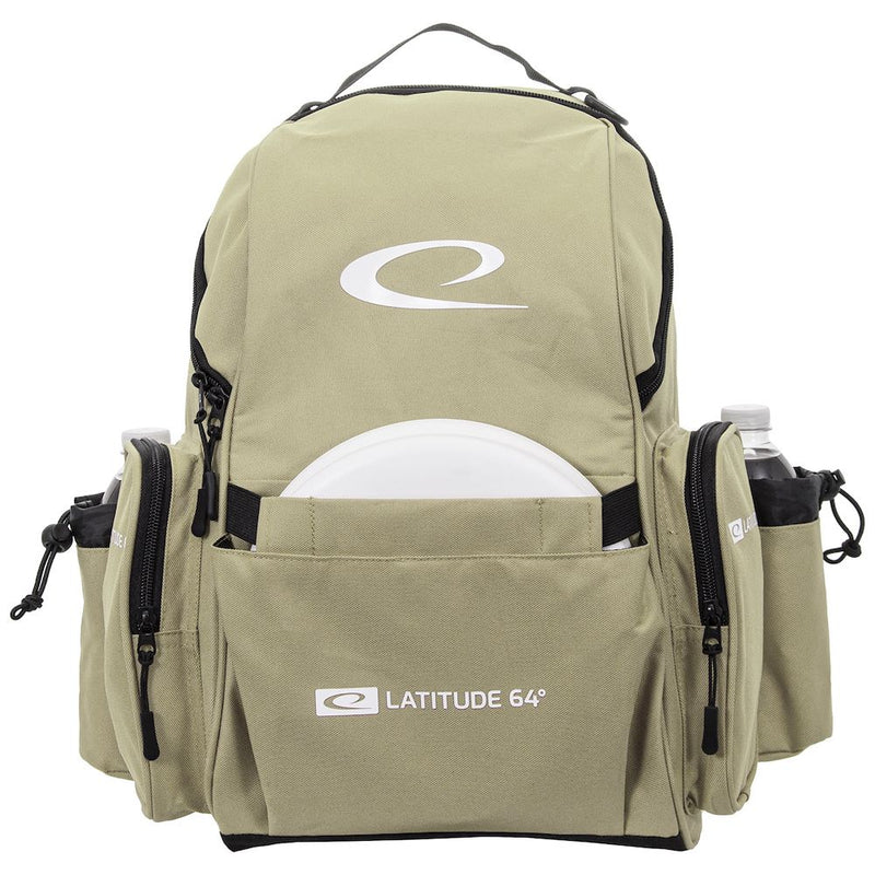 Khaki Latitude 64 Swift disc golf backpack with a white disc in the front pocket and two water bottles in mesh side pockets.