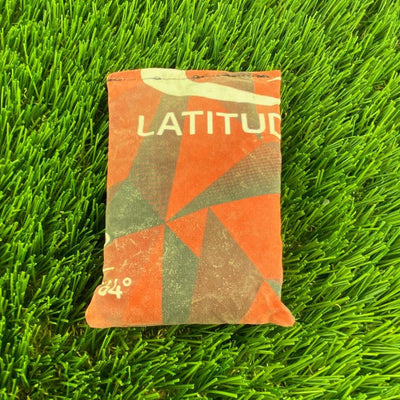 Orange and gray Latitude 64 Dirtbag Prism with a geometric pattern, showcasing the brand name and part of "64°".