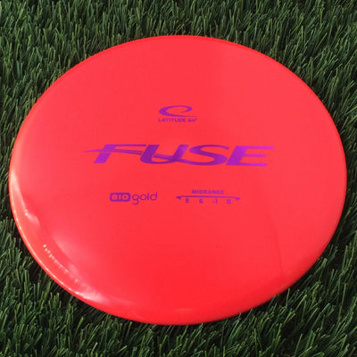 Solid red Latitude 64 Gold Line Bio Fuse disc golf midrange with purple branding and flight numbers.