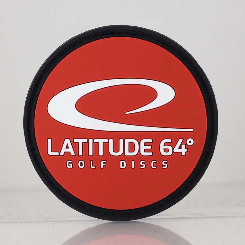 Round Latitude 64 collector patch with a black border surrounding a red interior and white swoosh logo.