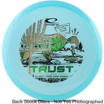 Light blue Latitude 64 Trust disc golf clear plastic disc with a gold and green Albert Tamm Team Series stamp.