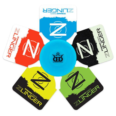 A light blue dynamic discs zlinger mini disc centered among five colorful zlinger bag tags.