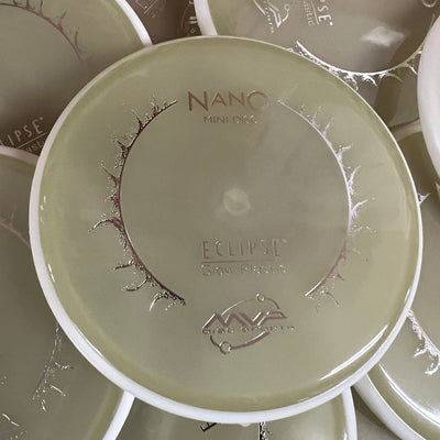 A light green mvp nano eclipse 20 mini marker disc with a white rim and silver foil stamp.